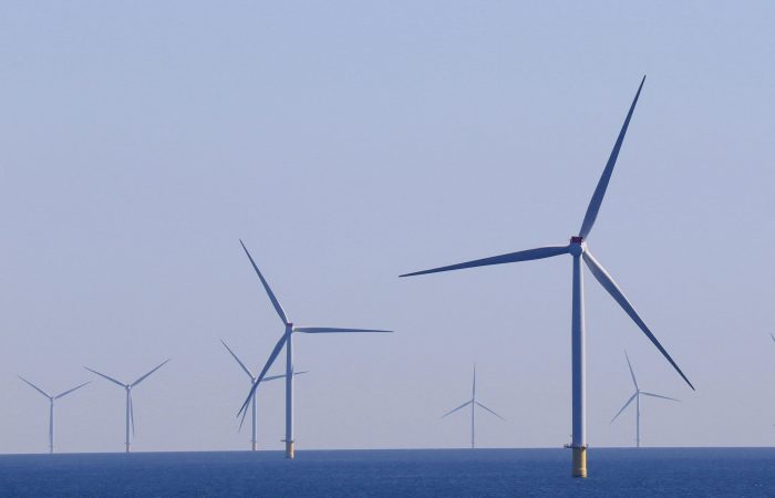 A series of offshore wind turbines generating renewable energy in a vast ocean landscape