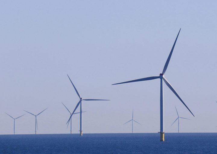 A series of offshore wind turbines generating renewable energy in a vast ocean landscape